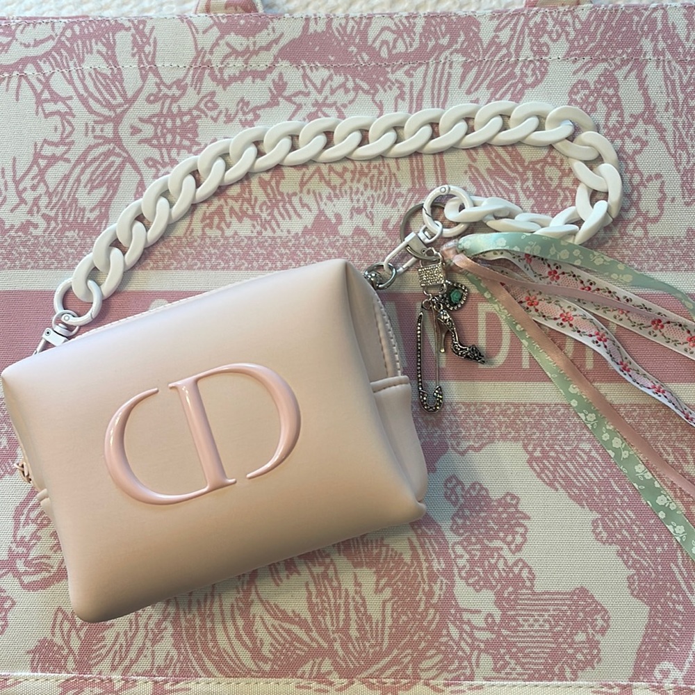 Dior authentic wristlet/hand/clutch purse in pale pink with pink “CD” logo.